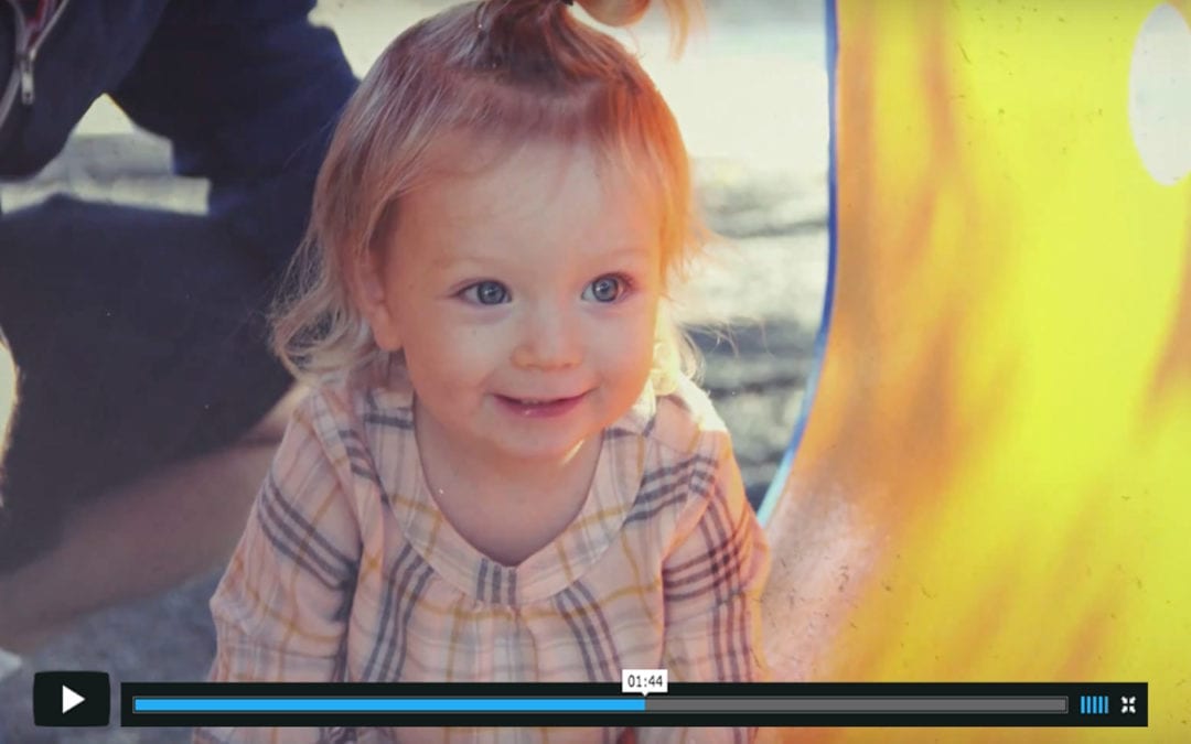 Baby smiling with Vimeo play button and bar below